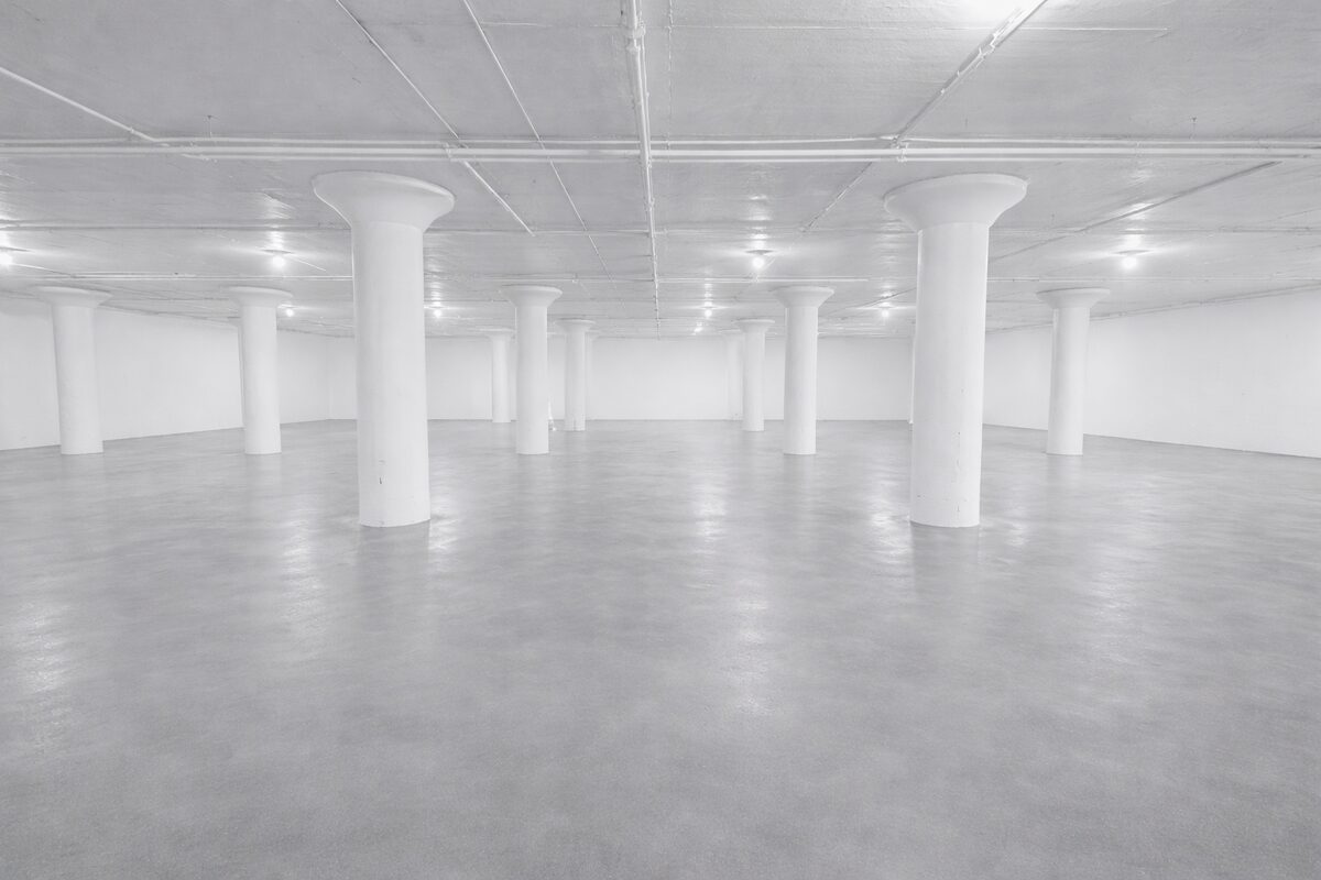 Expansive indoor storage floor with multiple column rows receding into background